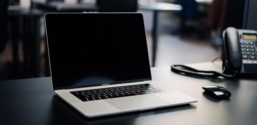 macbook pro on white table